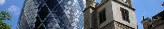 St Andrew Undershaft beneath the towering 'Gherkin' in the City of London