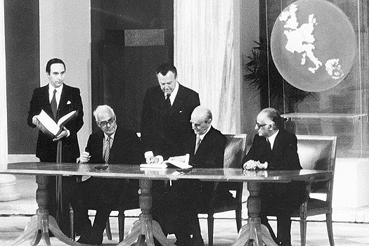 Greek PM Constantinos Karamanlis signs the accession treaty to the EEC