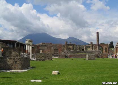 Mount Vesuvius looms threateningly in the background behind the Temple of Jupiter