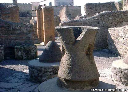 A little way north of the Forum lie the remains of a typical bakery on the Via della Terme